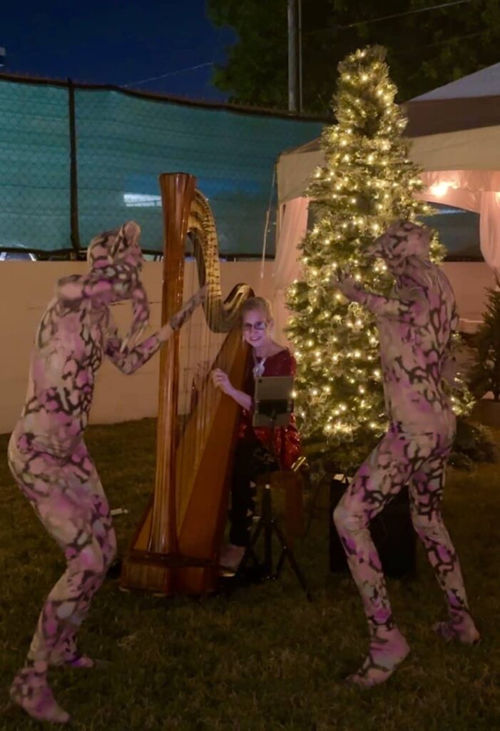 Corporate Christmas party with interesting beings dancing around the harp.